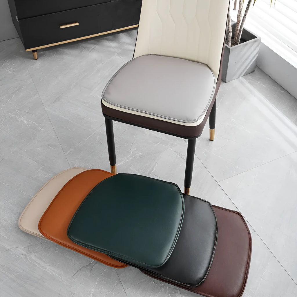 Orange leather horseshoe-shaped seat cushion with non-slip base, shown on a wooden chair.