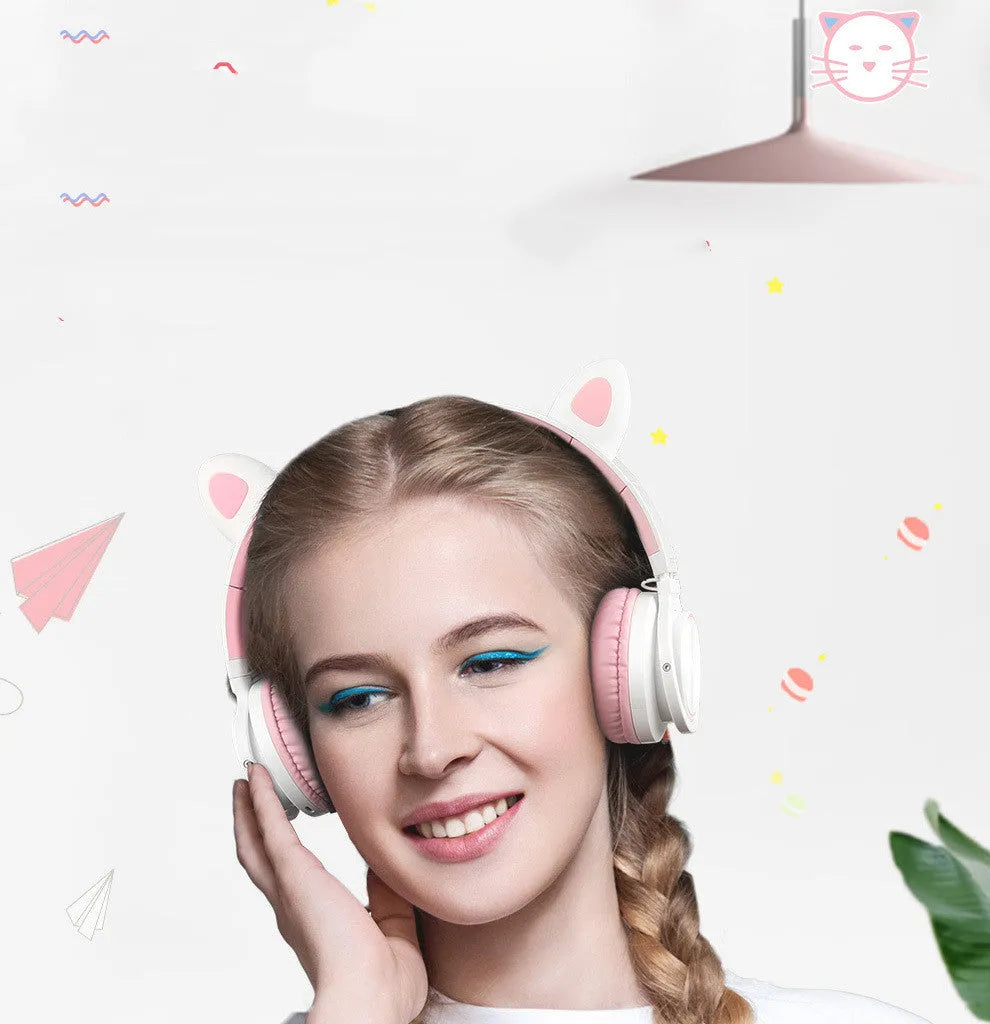 Pink and white wireless Bluetooth headphones with head-mounted design and braided cable