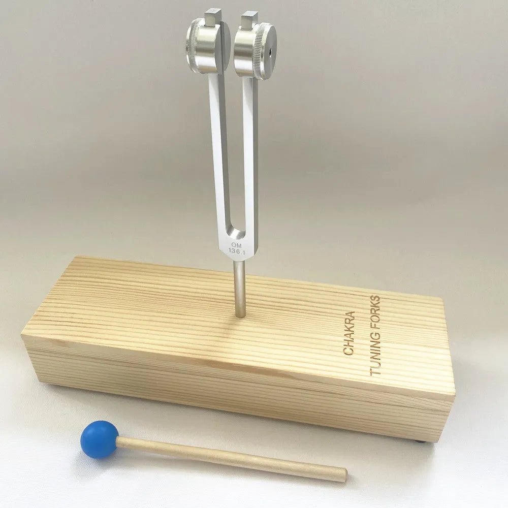 432Hz aluminium tuning fork and small speaker set on kraft paper packaging