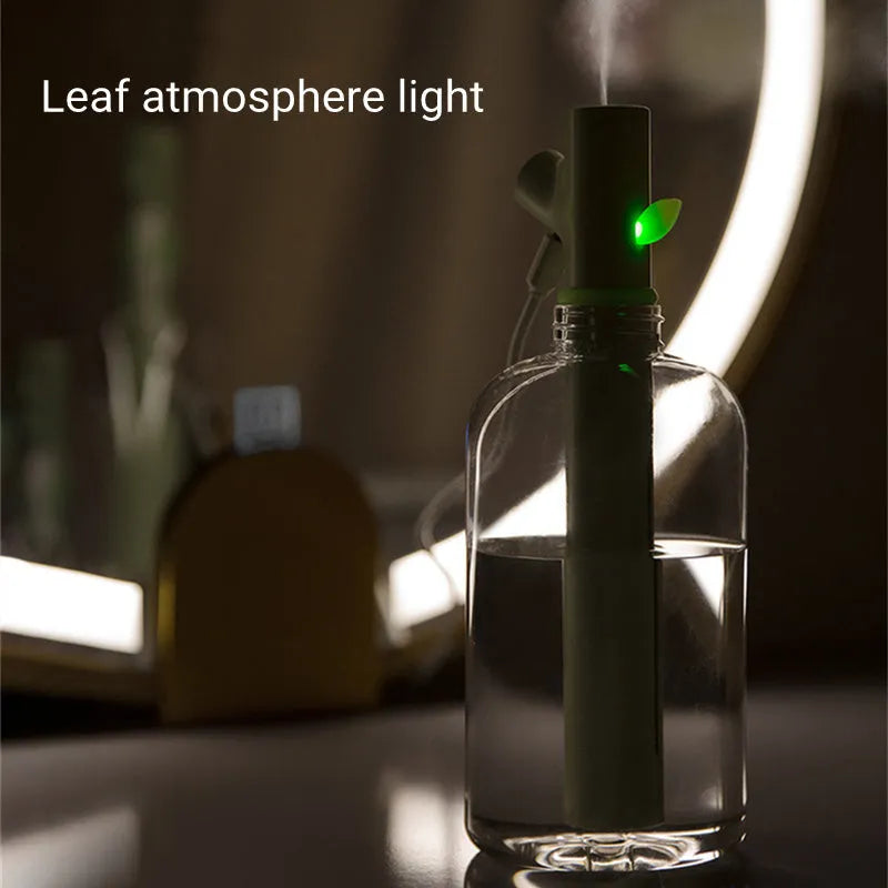 Transparent mini USB humidifier with water bottle design showing adjustable mist output