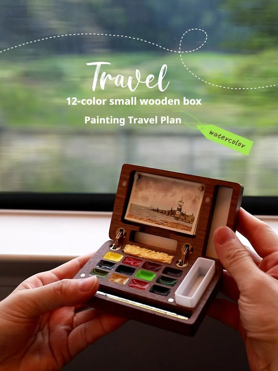 Mini walnut wood watercolour paint box open to show pigment suit selection