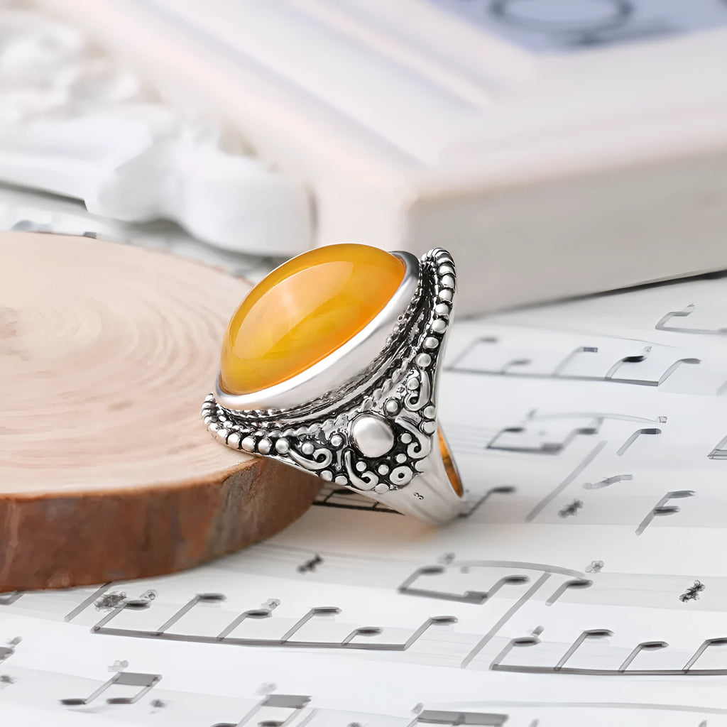 Fluorescent beeswax centre geometric ring in antique silver on a hand.