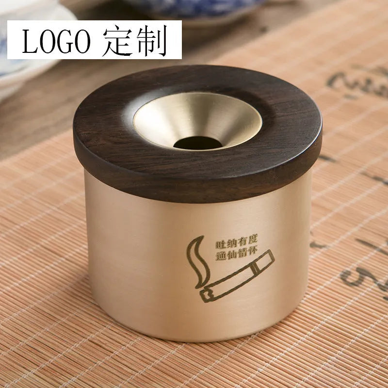Brass ashtray with wooden lid showing centre hole design and copper construction