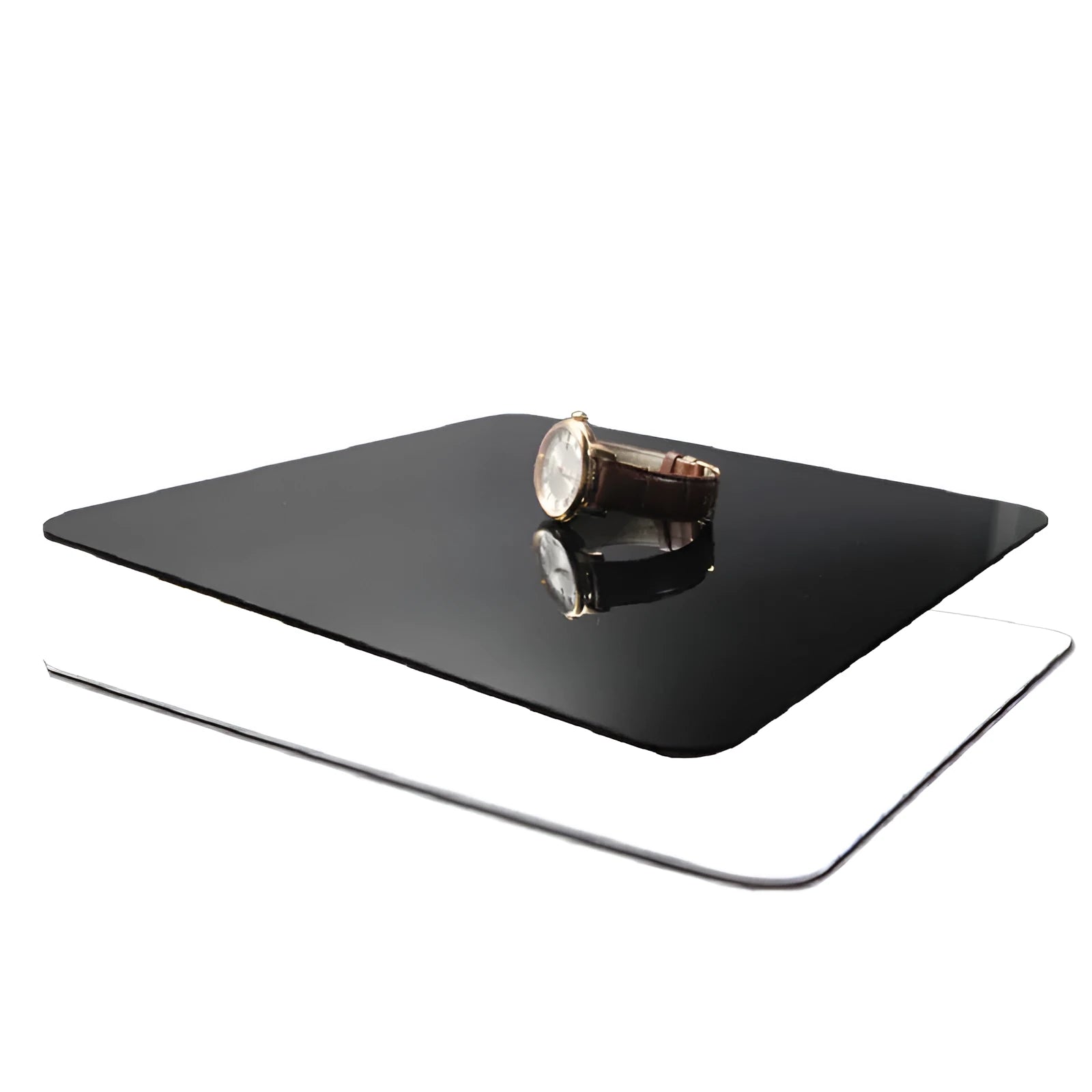 Black and white acrylic square reflection boards for product photography on a table
