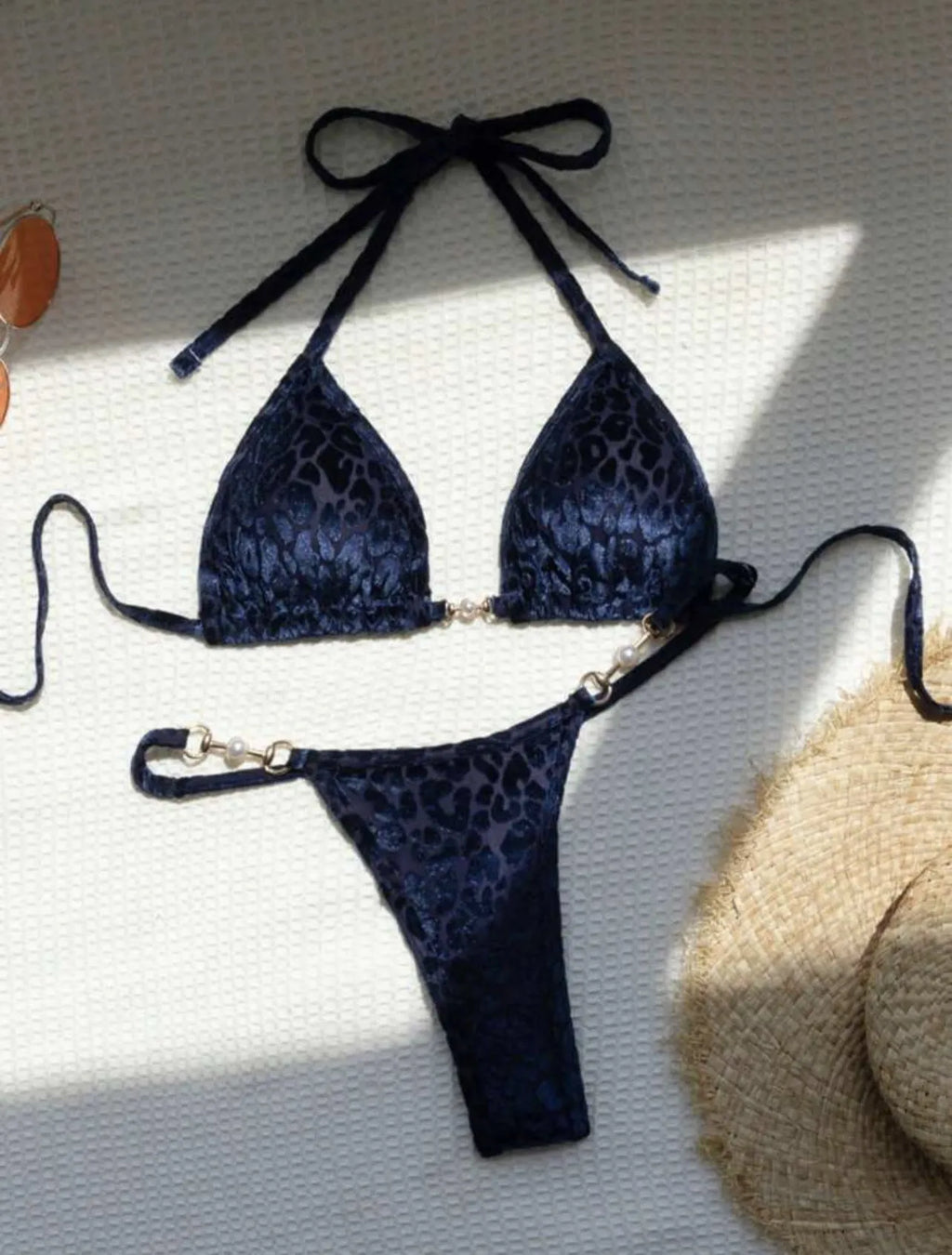 Blue leopard print women's polyester bikini set on a yellow background, showing a T-shaped sleeveless design.