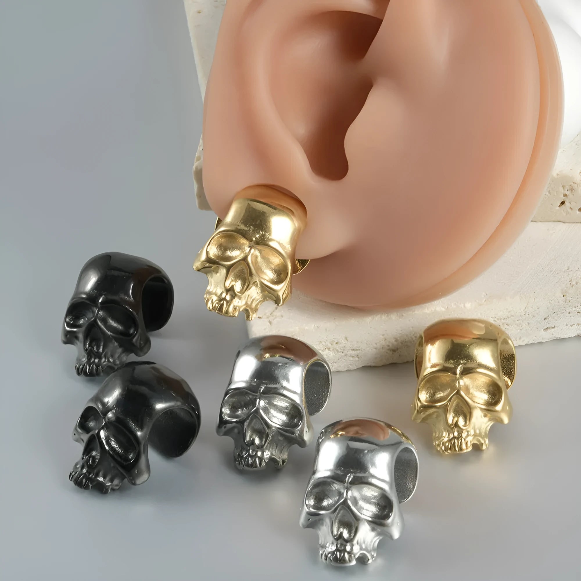 Stainless steel hollow skull Buddha earrings with electroplated colour finishes