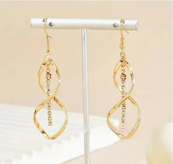 Gold geometric spiral design earrings with oval diamond shape for women