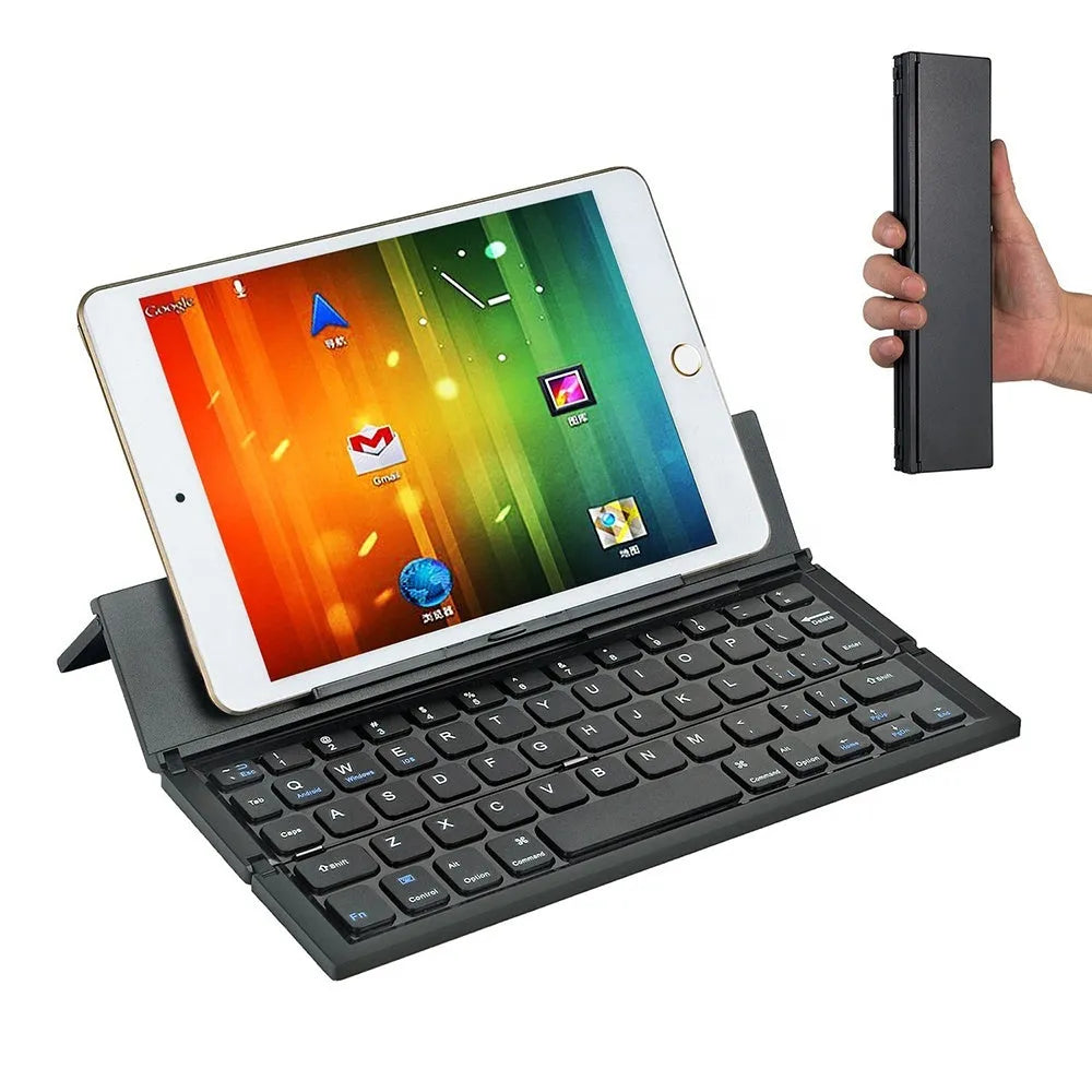 Black folding Bluetooth keyboard with numeric pad next to tablet