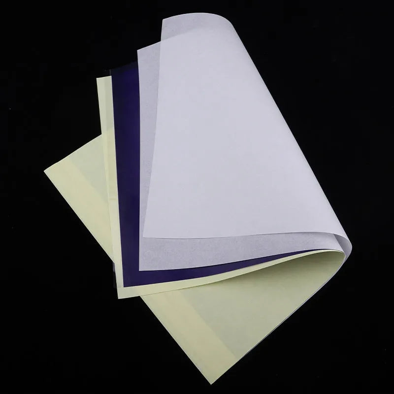 Stack of A4 tattoo transfer paper sheets with clear quadruple lines and transfer gel tube