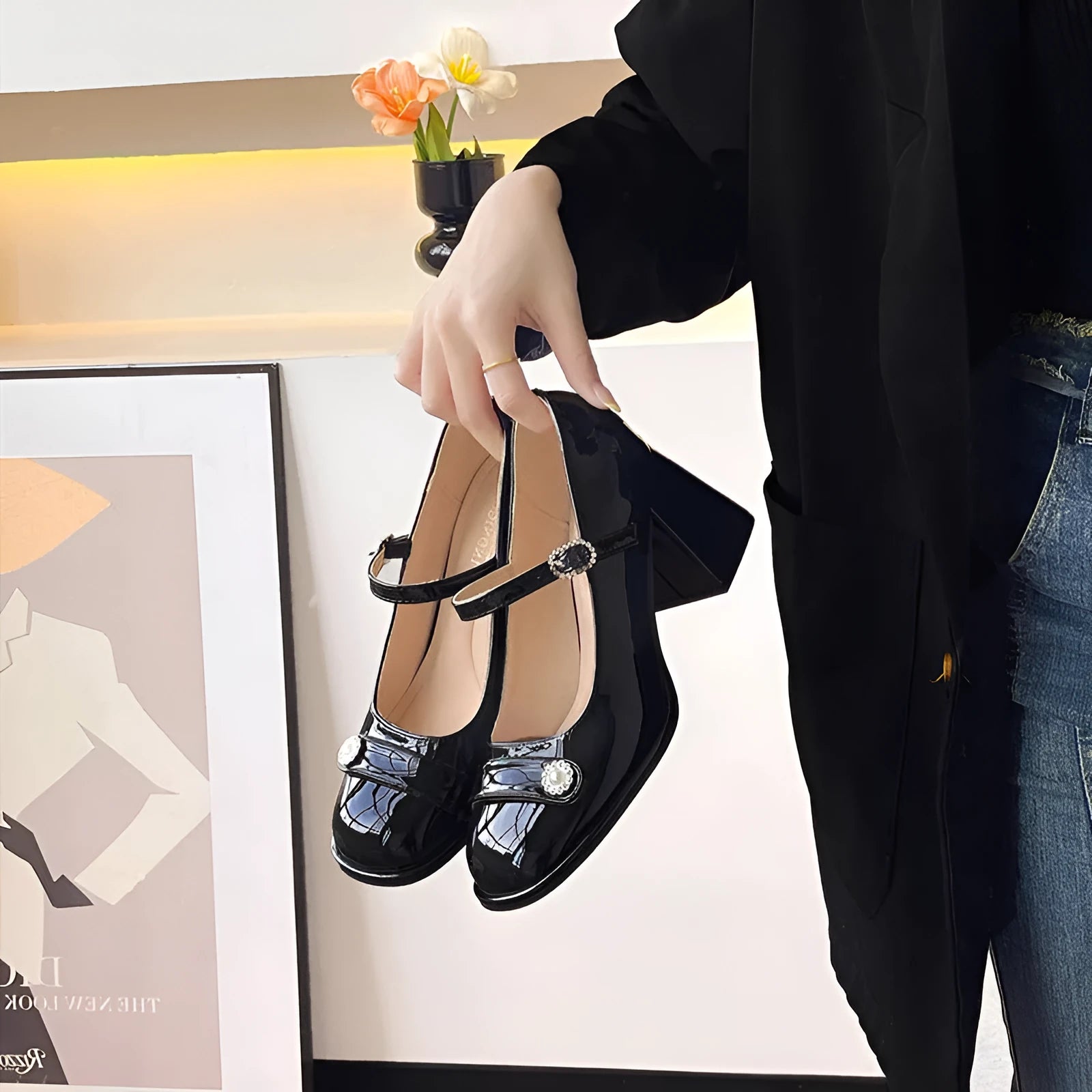 Women's black patent leather chunky heel round toe shoes with buckle fastening.