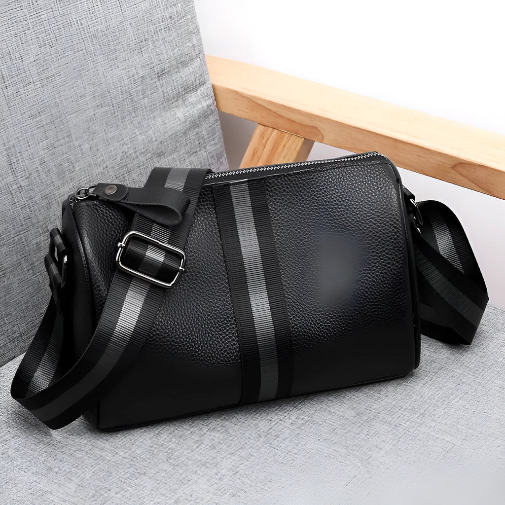 Black genuine leather women's crossbody bag showing front view and shoulder strap