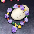 Natural shaped purple amethyst bead bracelet for women with a fu charm.
