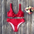 Women's solid colour bikini swimsuit set with matching bra top and bottom in polyester fabric