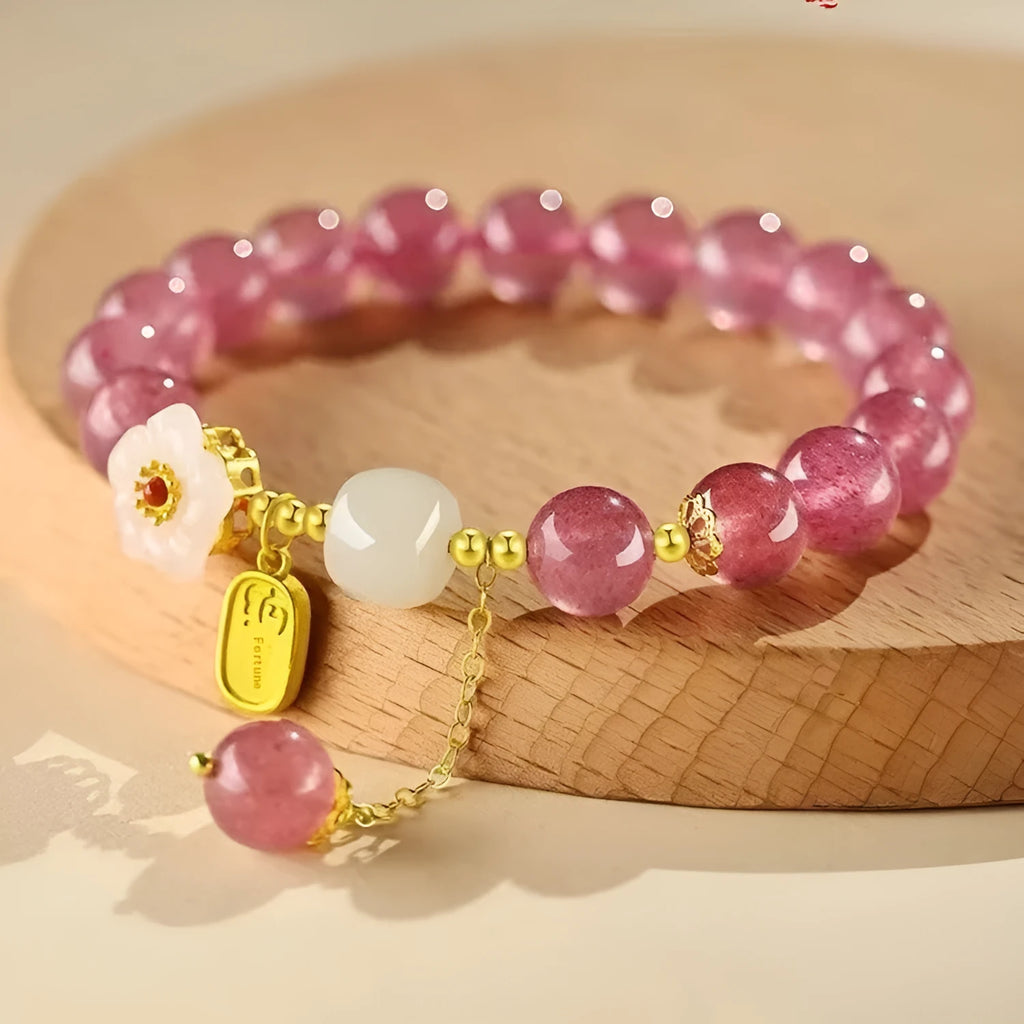 Handcrafted strawberry quartz and Hetian jade bracelet with peach blossom charm for girls.