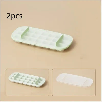 High-capacity plastic ice cube tray in blue with an ice shovel stored in a dedicated slot on the tray.
