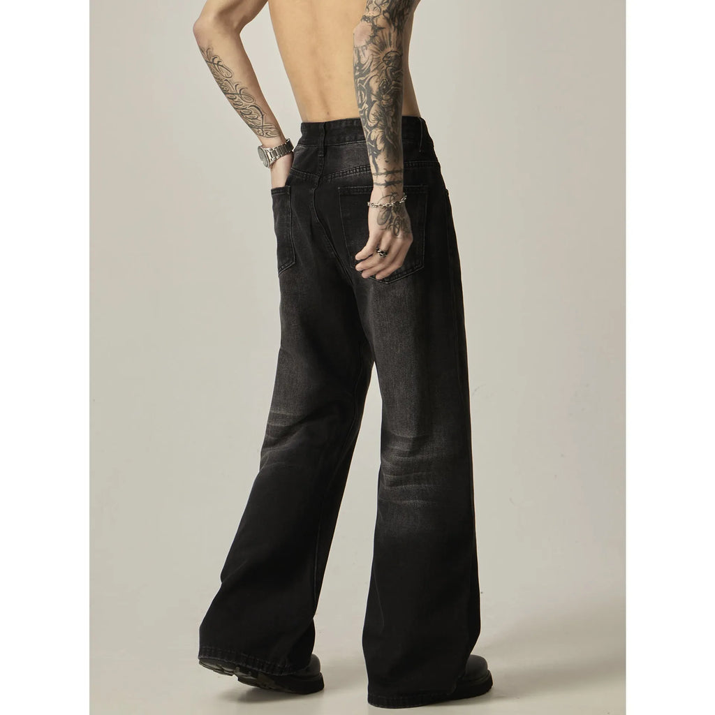 Black loose-fit straight-leg retro jeans with a zip fly on a neutral background.