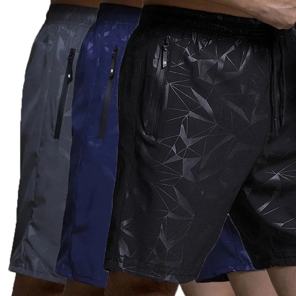 Man wearing loose grey polyester sports shorts on a beach.