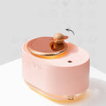 Planet-shaped rotating humidifier with night light in green, pink or white colours showing USB charging port