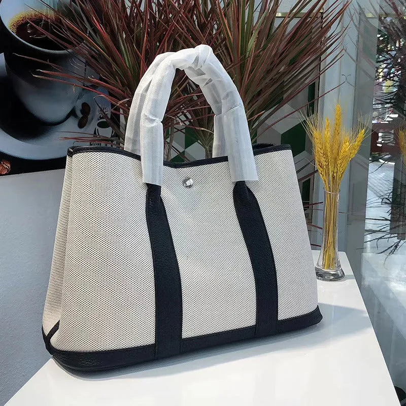 Women's canvas bucket tote bag with genuine leather details in black colour option
