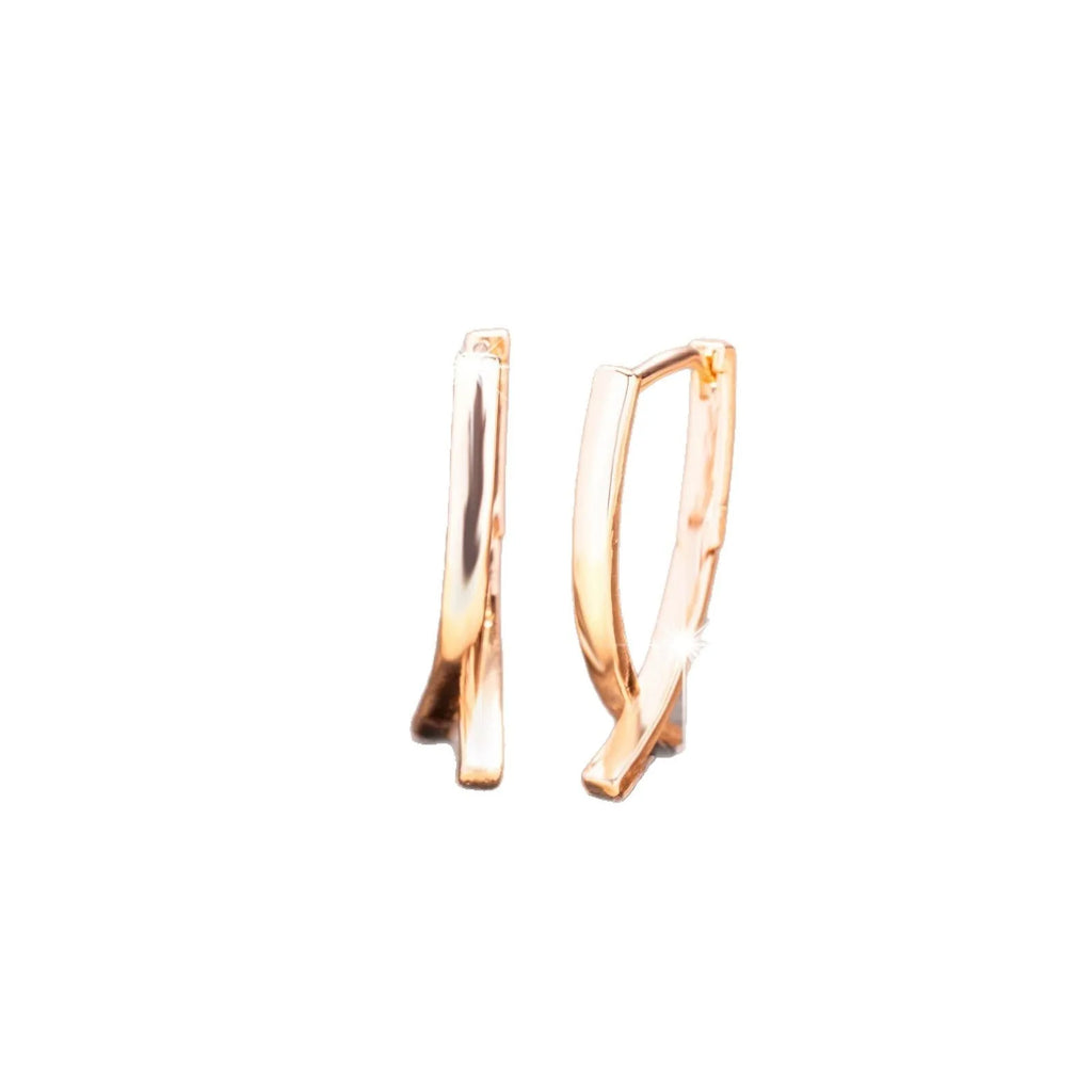 Cross shaped earrings in rose gold colour made from copper material