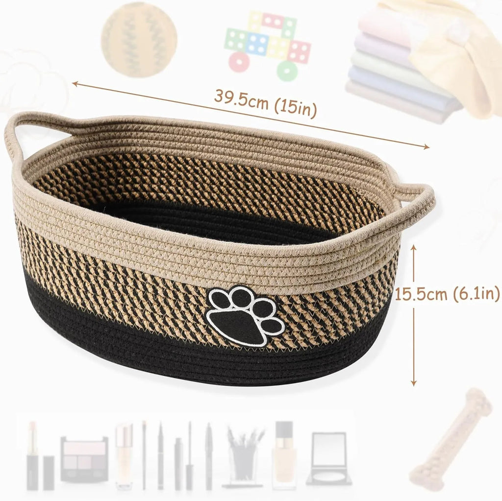 Light beige handmade woven cotton rope storage basket with wooden handle on a table.
