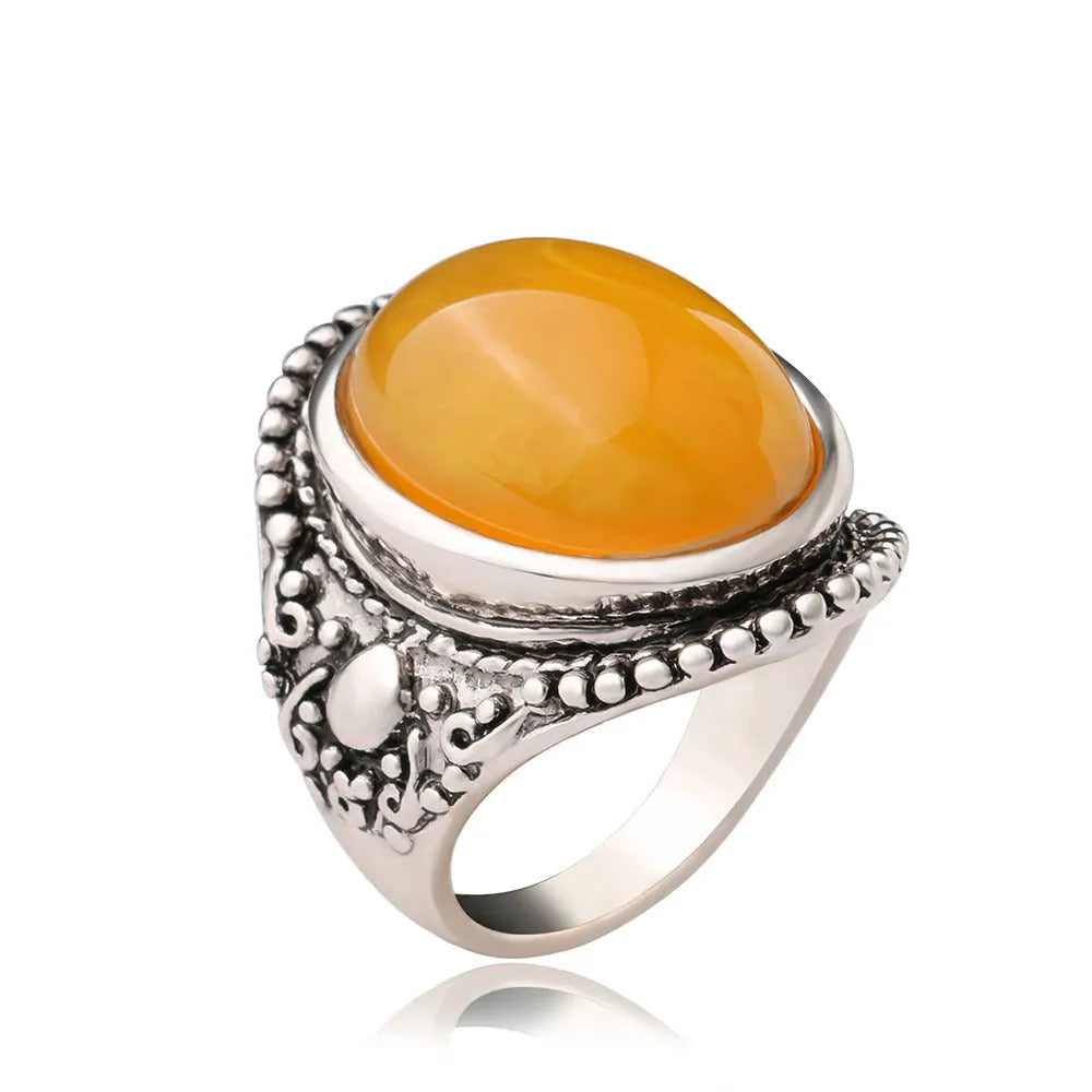 Fluorescent beeswax centre geometric ring in antique silver on a hand.