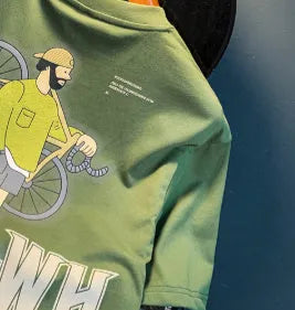 Green loose-fit men's t-shirt with a printed design on the front, featuring short sleeves.