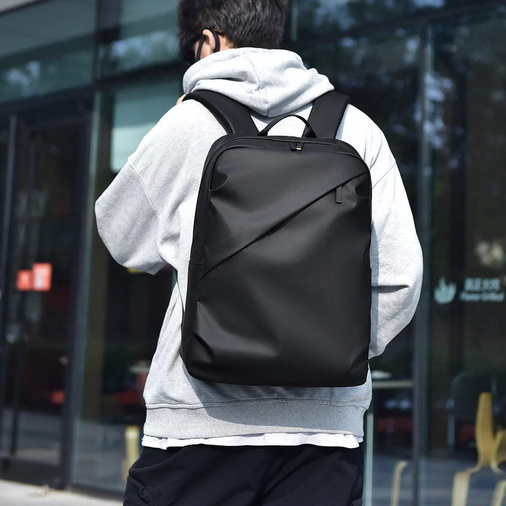 Large black waterproof PU leather backpack with sewing thread detail, shown from a side angle.