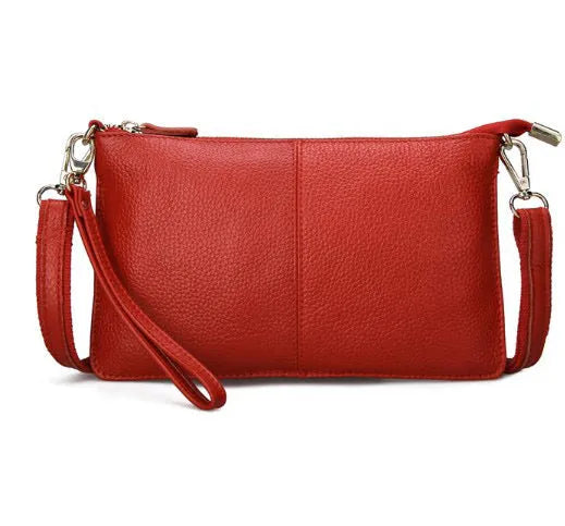 Cowhide lady's slant bag showing front compartment, adjustable long shoulder strap, and hand strap in a choice of colours