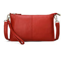 Cowhide lady's slant bag showing front compartment, adjustable long shoulder strap, and hand strap in a choice of colours