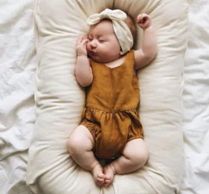 Beige portable cotton baby nest bed crib for newborns, measuring 75 cm by 45 cm.