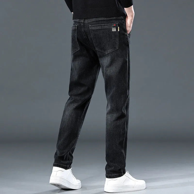 Man wearing slim straight blue-grey casual trousers with a micro-elastic fit and zipper fly.