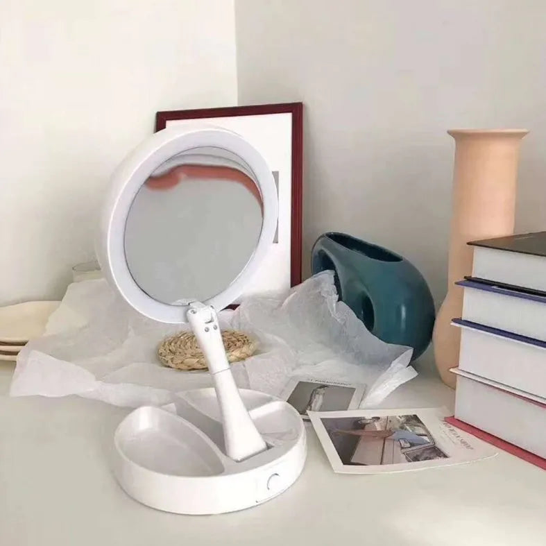 White acrylic double-sided vanity mirror with LED lights and a foldable stand.
