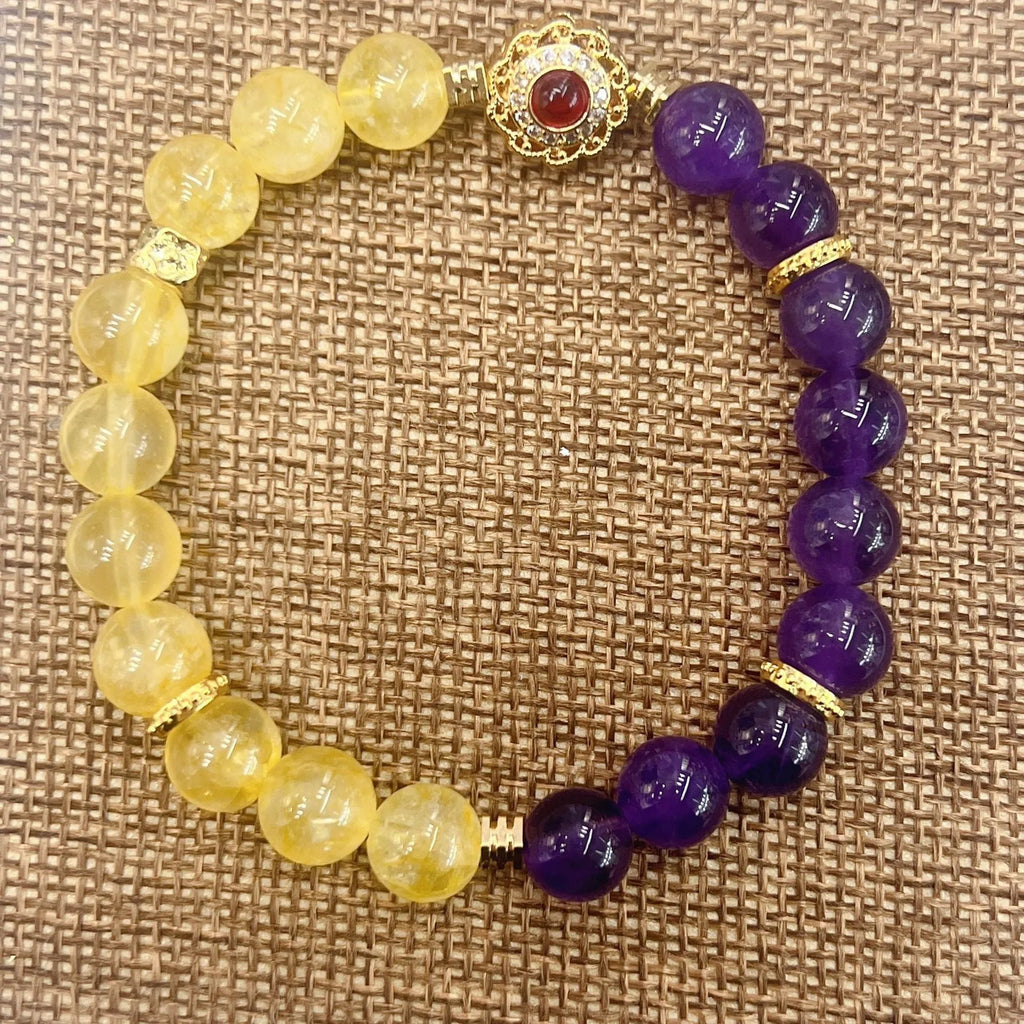 Handmade yellow and purple crystal women's bracelet on wrist.