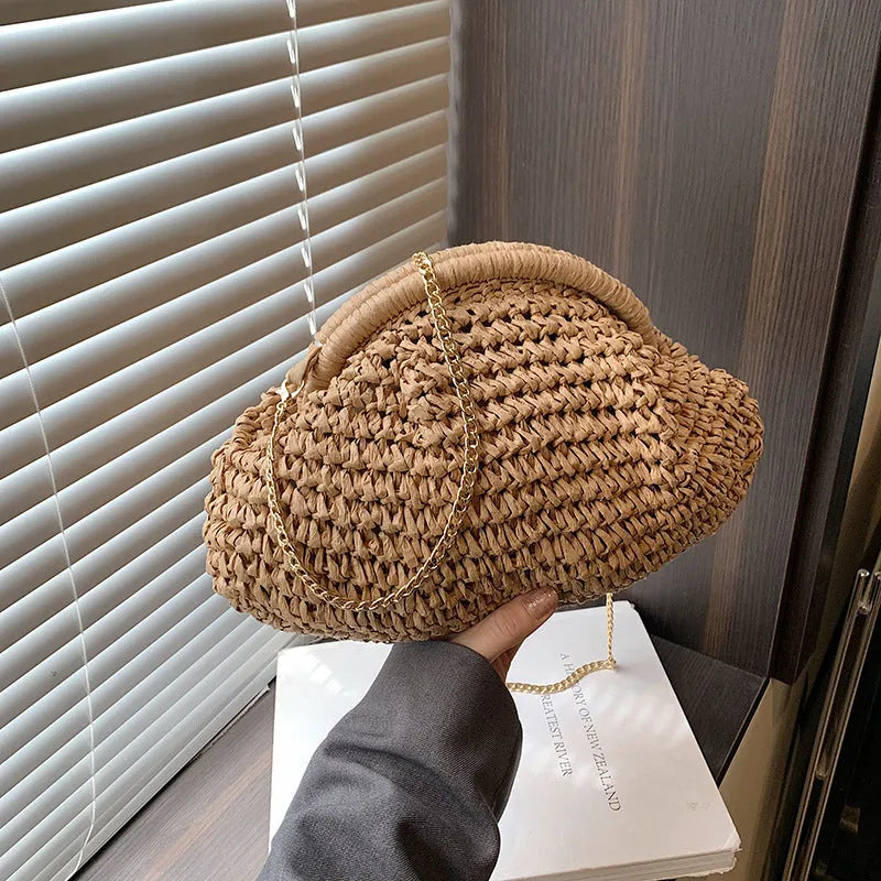 Khaki shell-shaped straw shoulder bag for women with chain detail and an internal zipper pocket.