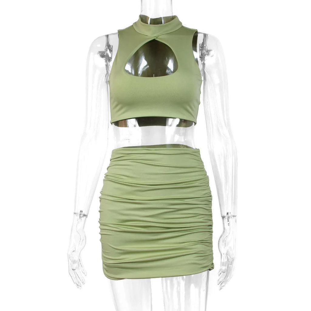 Women's light purple two-piece set with a hollow-out vest and a split hip skirt.