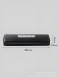 Black automatic vacuum sealer machine for household food preservation on kitchen counter