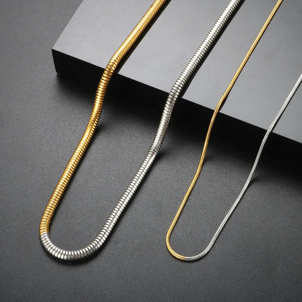 Women's stainless steel snake bone chain necklace with gold finish and geometric line detailing