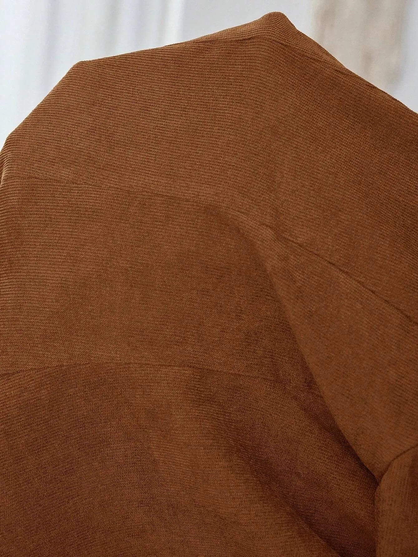 Brown men's single-breasted casual blazer with lapel collar and long sleeves on a hanger.