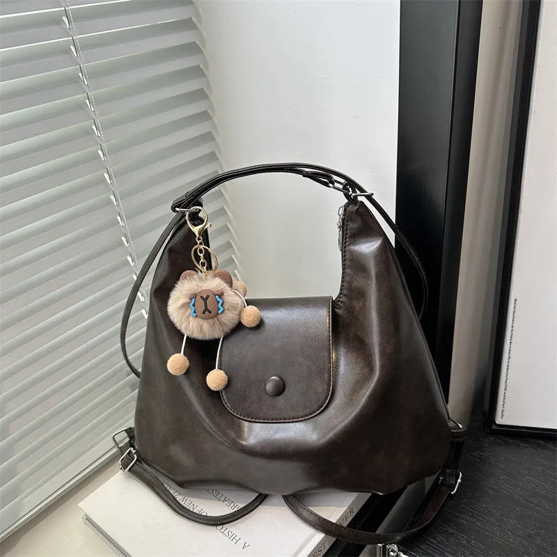 Textured PU leather women's single shoulder bag in horizontal square shape with optional pendant detail