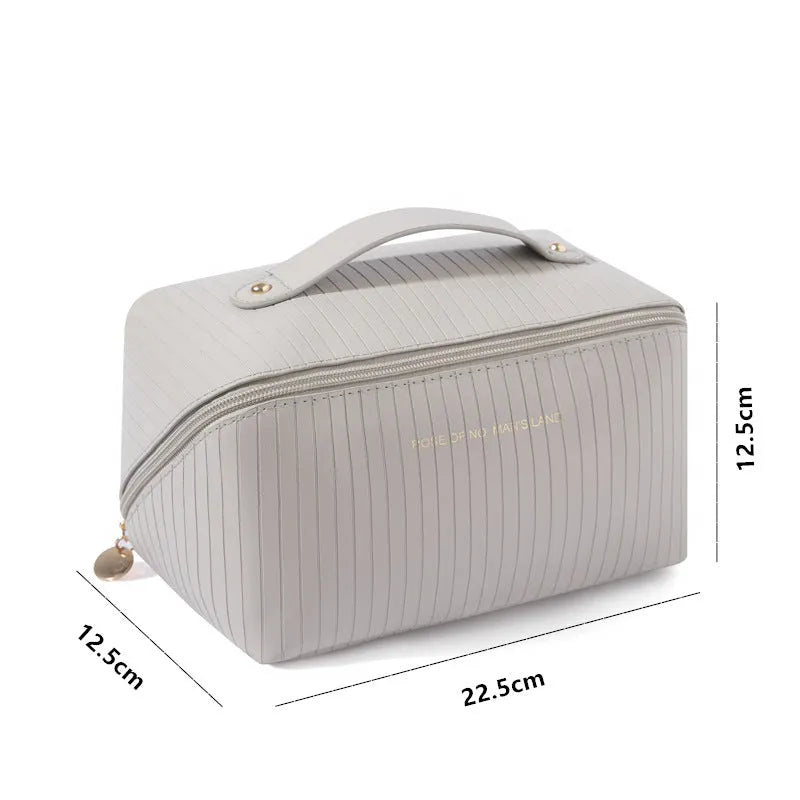 Cubic pillow-shaped PU makeup bag in a vertical pattern, shown in one of five colours: beige, black, brown, grey, or pink.