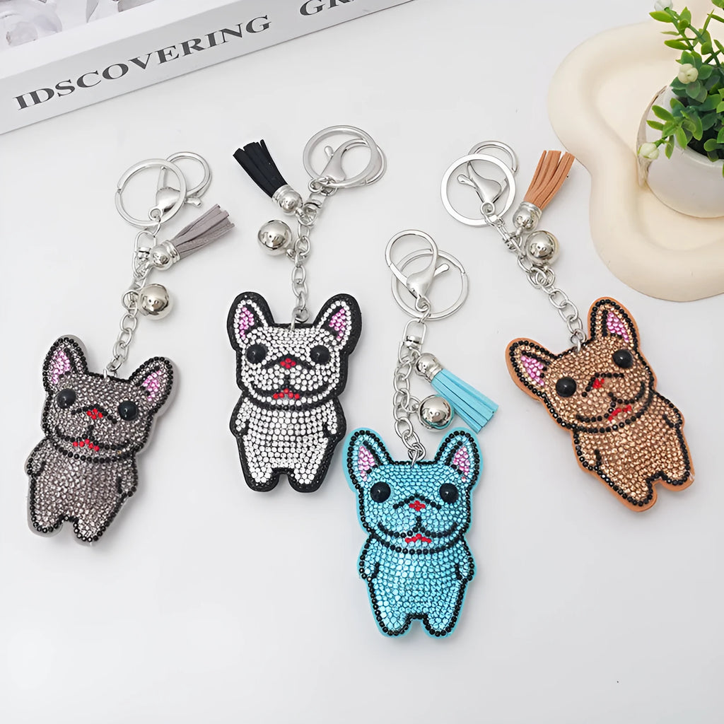 Close-up of a French dog-themed rhinestone keychain pendant with a cartoon bear design, in caramel colour.