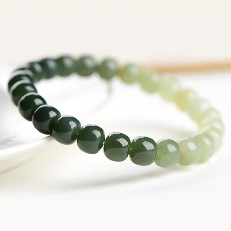 Natural Hetian jade bracelet with water gradient colouring showing polished stones in casual unisex design