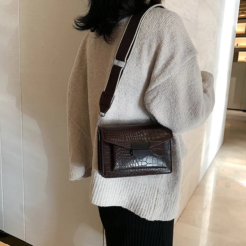 Vintage PU leather crossbody bag in black showing 20cm width and crossbody strap