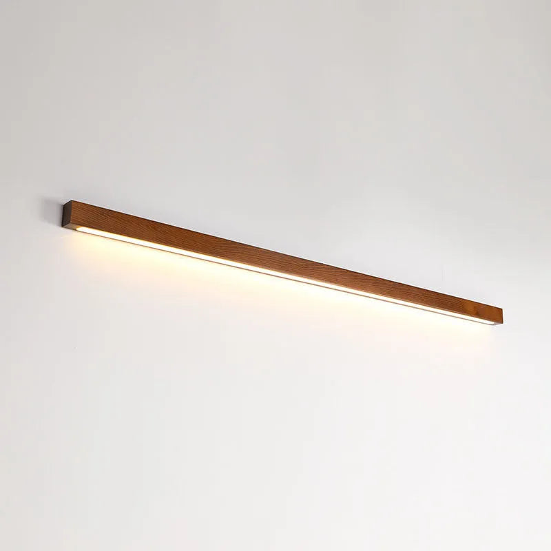 Walnut colour solid wood and acrylic LED strip wall lamp in three different lengths.