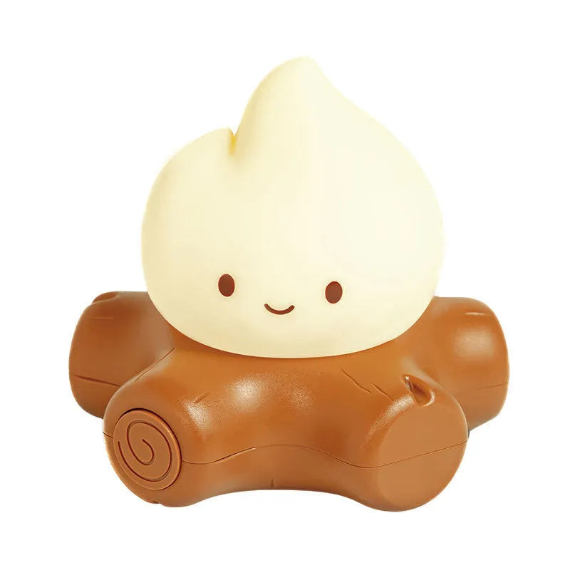 Silicone small fire pile shaped cartoon night light with yellow glow on a surface.