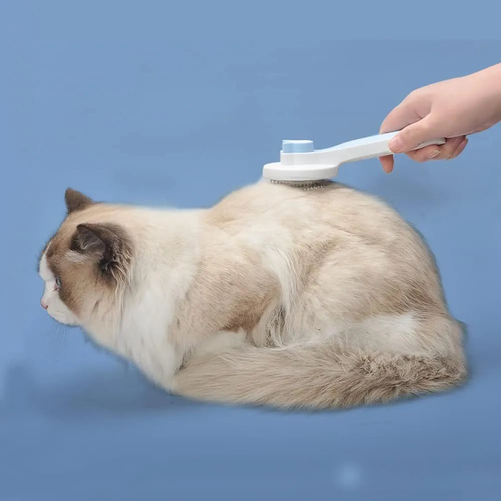 Blue self-cleaning cat and dog grooming brush with rubber handle and metal pins.