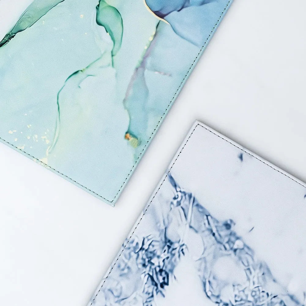 Durable heat-insulating anti-radiation tablet pad in four colour variations on a desk