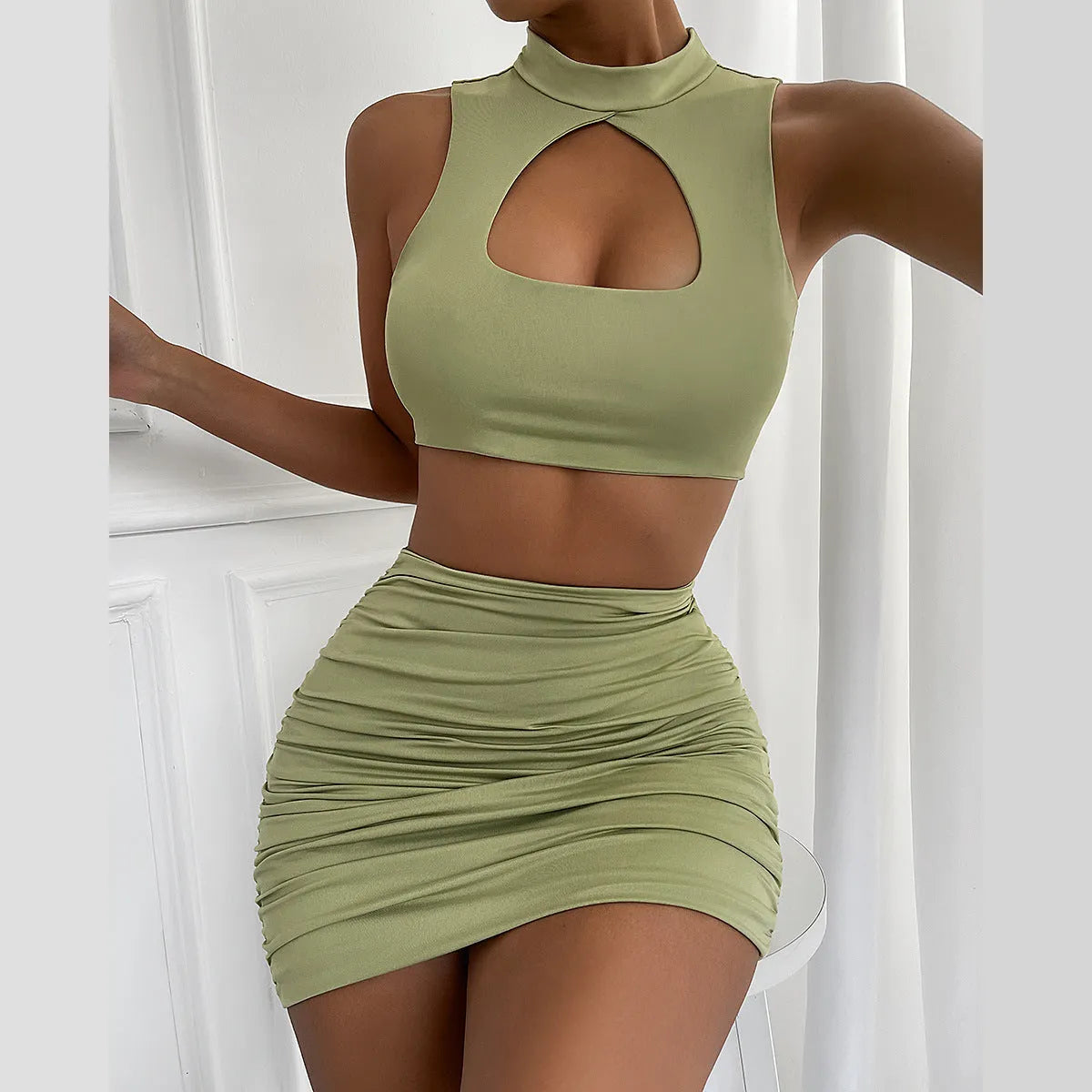 Women's light purple two-piece set with a hollow-out vest and a split hip skirt.