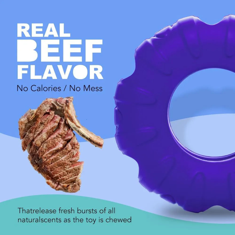 Blue natural rubber tyre-shaped dog chew toy and slow feeder with oval openings for treat dispensing.